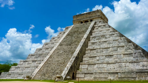 Low angle view of historical building against cloudy sky