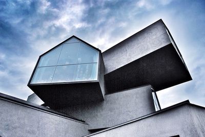 Low angle view of building against cloudy sky