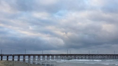 Scenic view of beach against sky during winter