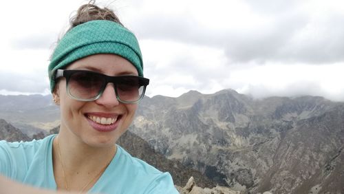 Portrait of smiling woman against mountains
