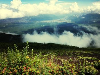 Scenic view of mountains against cloudy sky