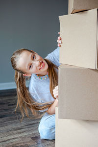 Portrait of young woman sitting on sofa at home