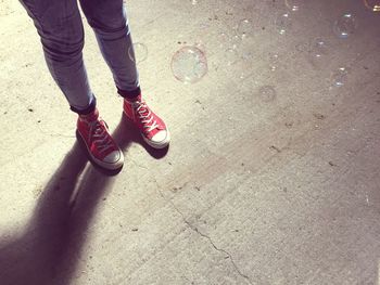 Low section of woman standing on tiled floor