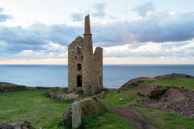 Historic building by sea against sky