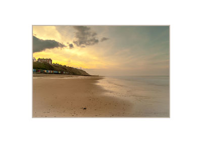 Scenic view of beach against sky during sunset