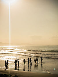 People on beach against sky