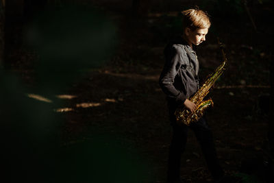 Full length of teenage girl playing at night