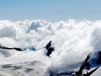 Snow covered landscape against cloudscape