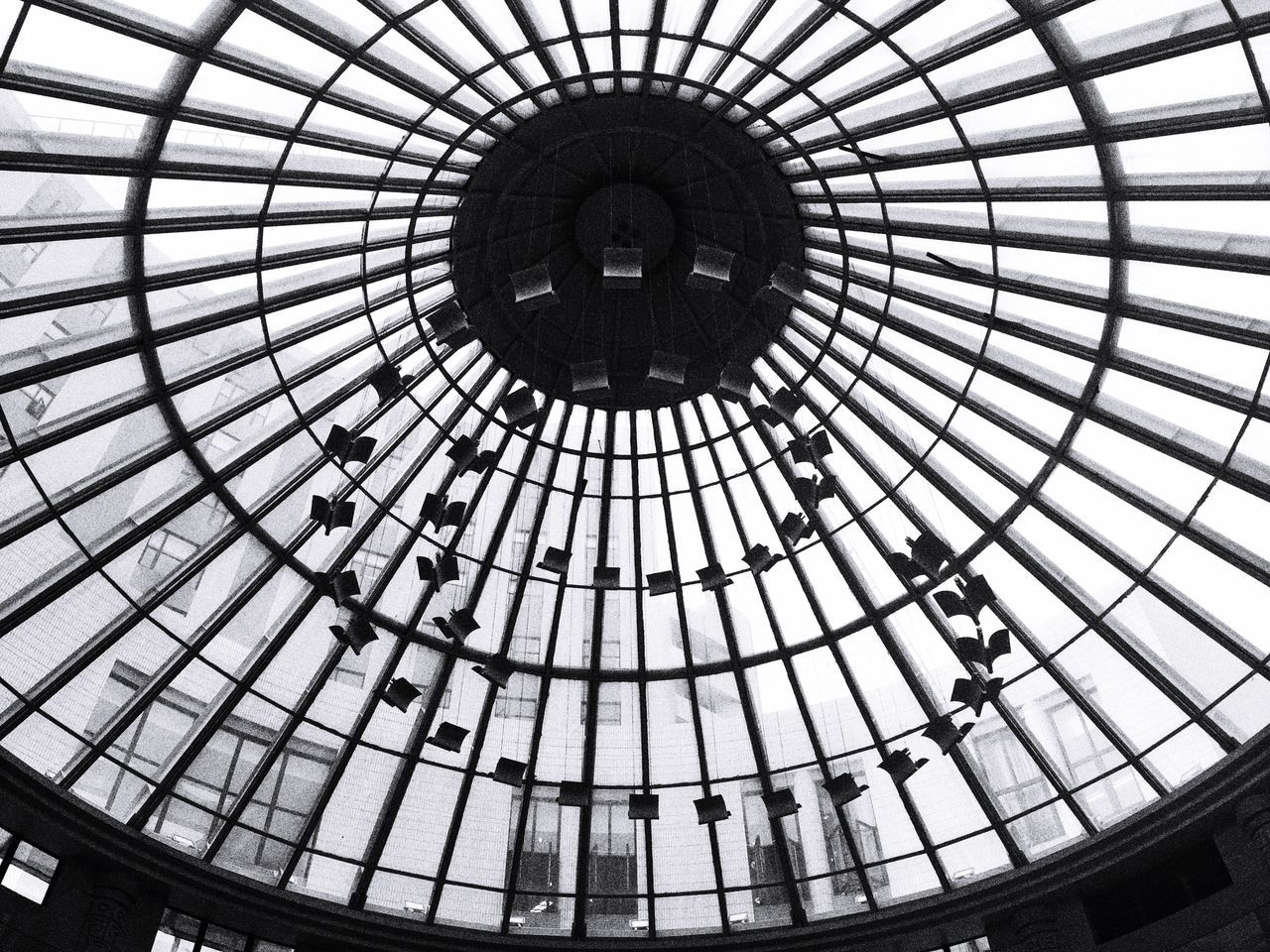 indoors, ceiling, architecture, low angle view, built structure, skylight, glass - material, pattern, architectural feature, directly below, circle, modern, dome, geometric shape, interior, transparent, design, famous place, shopping mall, travel