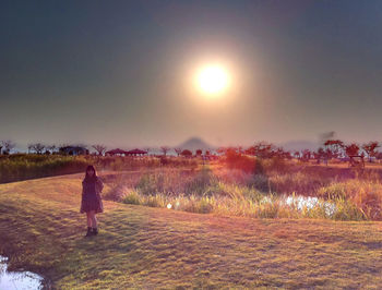 People standing on grassy field
