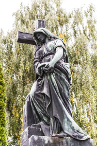 Low angle view of statue against trees