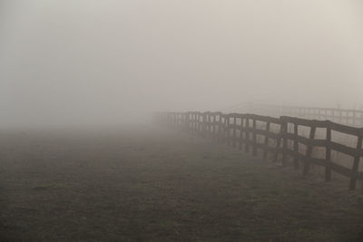 Scenic view of field against sky during foggy weather