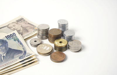 High angle view of coins on white background