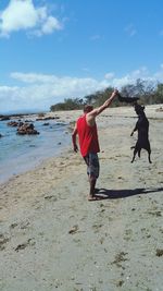 Full length of woman standing on beach