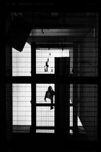 Silhouette man in window