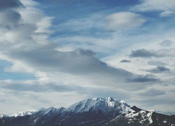 Scenic view of snow covered mountains against sky