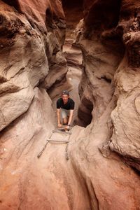 Portrait of young man amidst rock formations