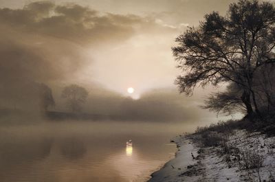 Scenic view of lake against sky during winter