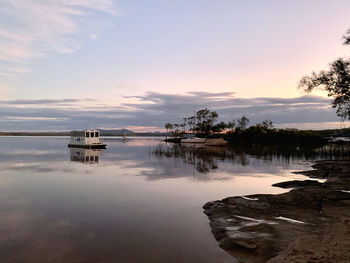 Scenic view of lake against sky during sunset