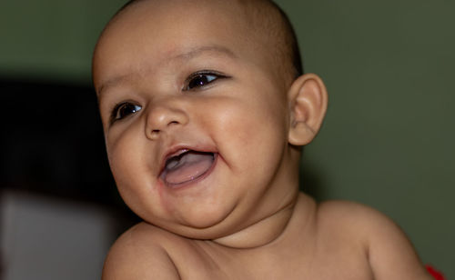 Baby infant cute innocent facial expression with blurred background