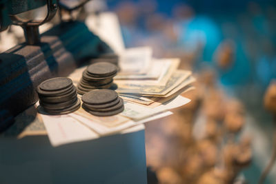 High angle view of weight scale with money on table