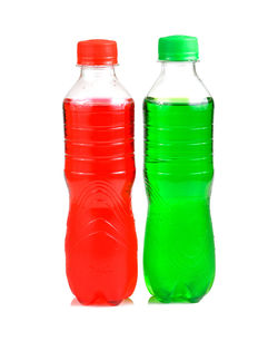 Close-up of green bottles against white background