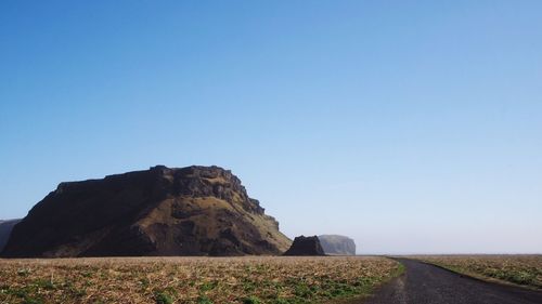 Scenic view of mountains against clear blue sky