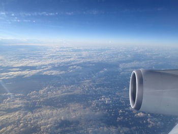 Cropped image of airplane wing over landscape