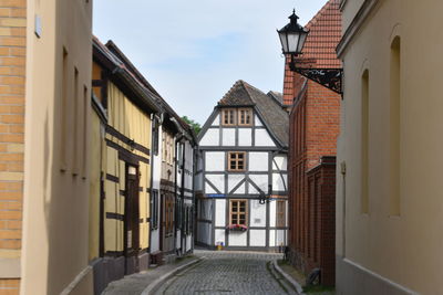 Street amidst buildings against sky