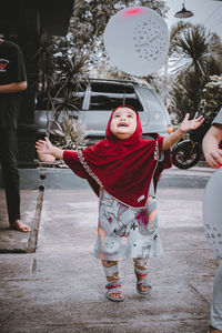 Happy girl playing with balloons