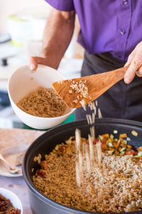 Midsection of man preparing food