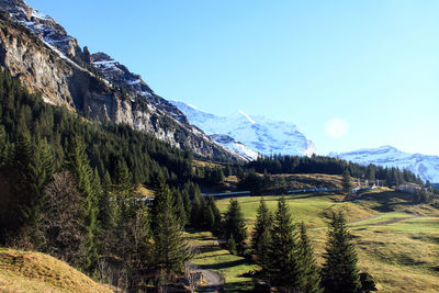 Scenic view of mountains against clear blue sky