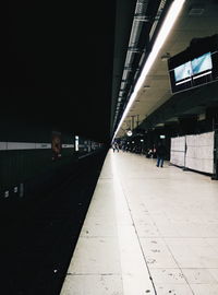 Railroad tracks in city at night