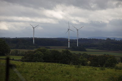 Windmill on field against sky