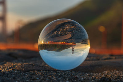 Close-up of crystal ball on shore