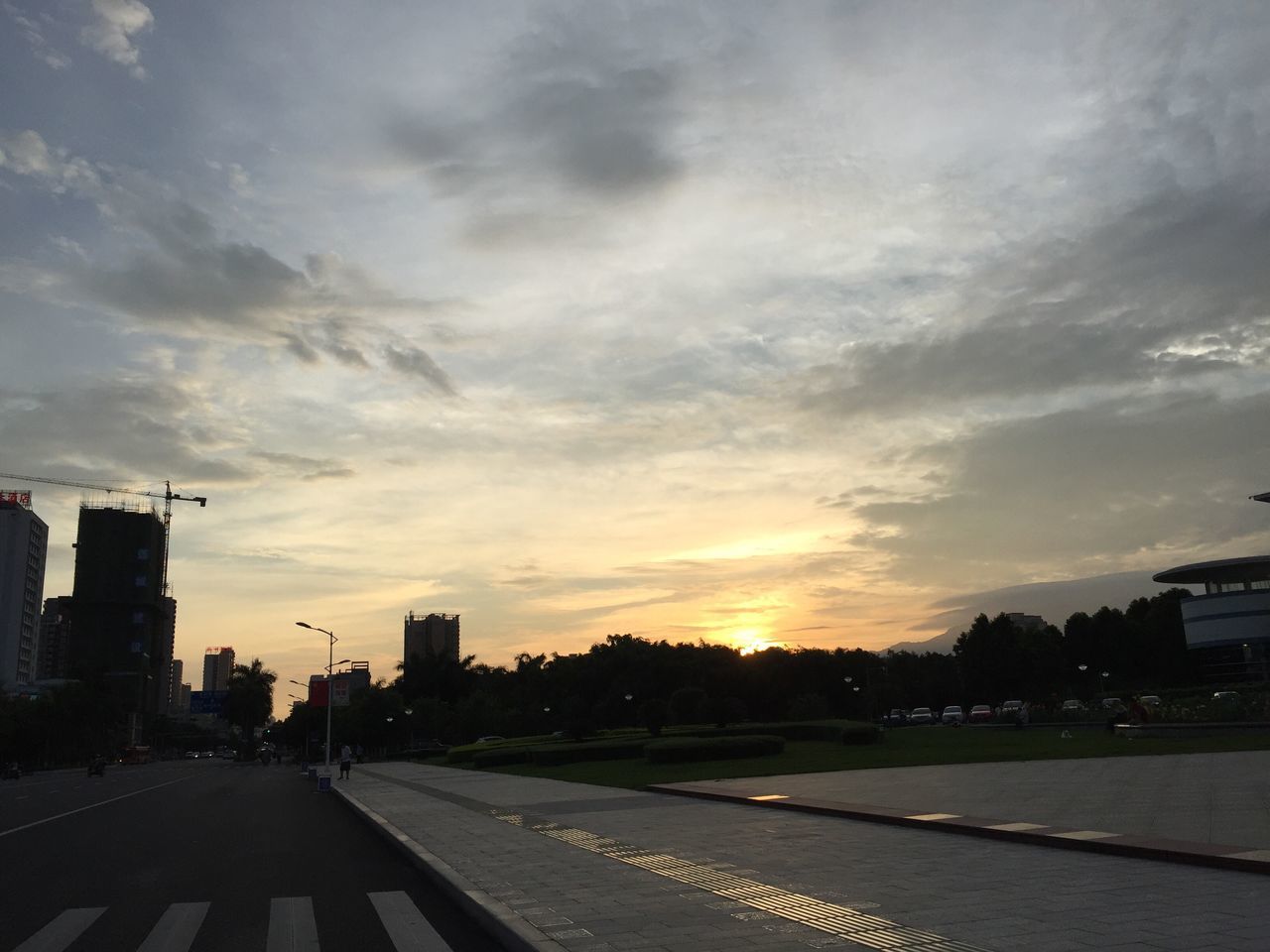 sunset, architecture, built structure, building exterior, cloud - sky, city, sky, no people, skyscraper, road, travel destinations, outdoors, cityscape, nature, tree, day