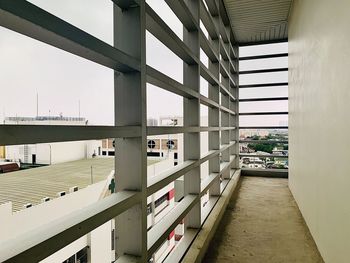 Empty corridor of building against clear sky