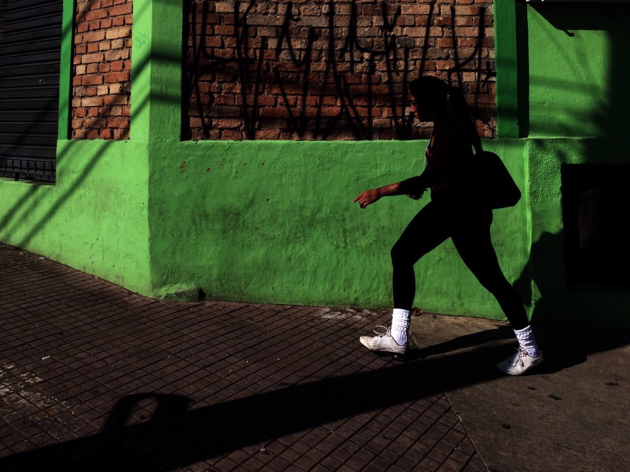 full length, lifestyles, leisure activity, childhood, shadow, casual clothing, sunlight, side view, sidewalk, elementary age, street, built structure, boys, men, day, sitting, girls, holding