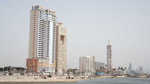 Modern buildings in city against clear sky