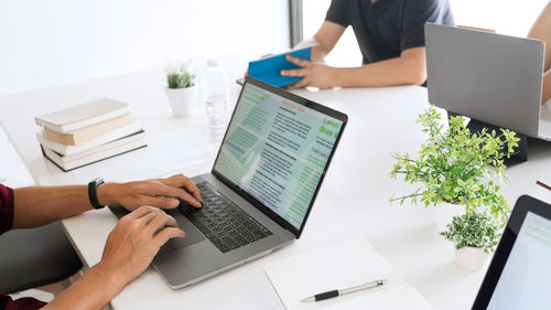 Low angle view of man using laptop on table