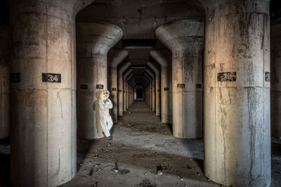 Man wearing bunny suit in abandoned building