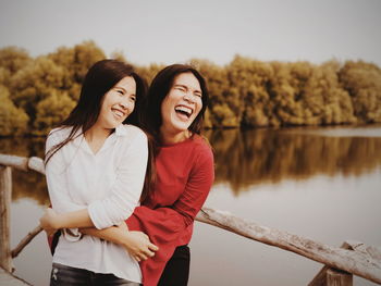 Portrait of smiling young women against sky