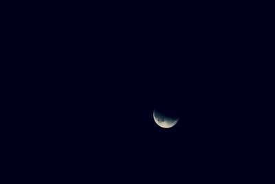 Low angle view of half moon against sky at night