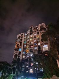 Low angle view of illuminated building against sky at night