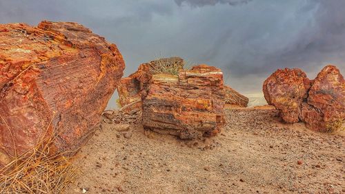 Rock formation on beach against sky