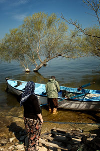 Full length of people boarding a boat