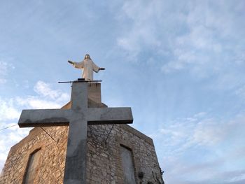 Low angle view of statue against sky