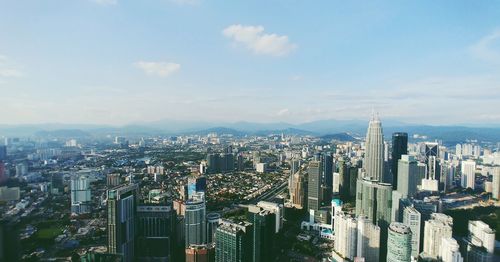 High angle view of modern buildings in city against sky