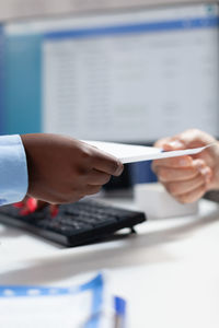 Close-up of business people working in office