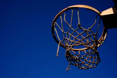 Low angle view of basketball hoop against blue sky